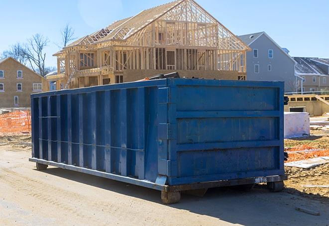 a residential dumpster overflowing with demolition debris